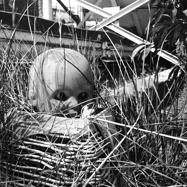 Once a doll decorating a flower bed, over time it turned into a character in horror films.... - My, Doll, Horror, Photo, Black and white, Humor, Flower bed