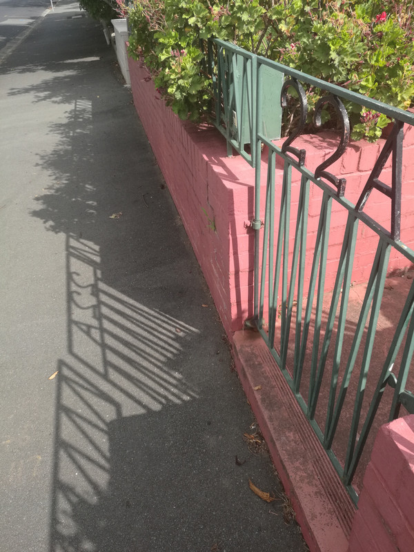 The shadow in front of the gate hints that this is a back door - Shadow, Booty, Back door