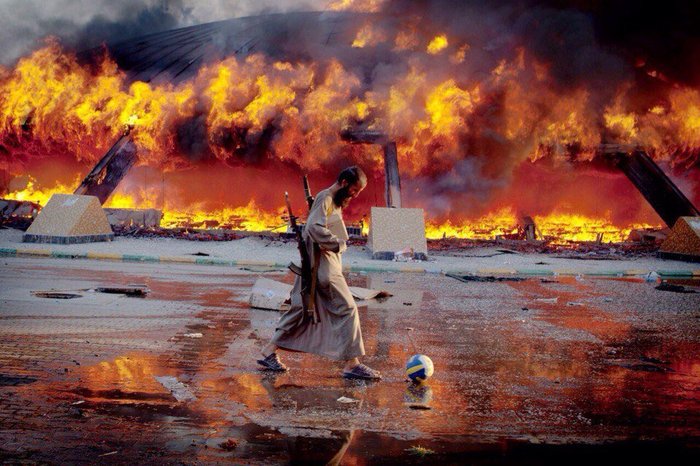 The rebel plays football against the backdrop of the burning residence of M. Gaddafi. - Not mine, From the network, Gaddafi, Football, Muammar Gaddafi