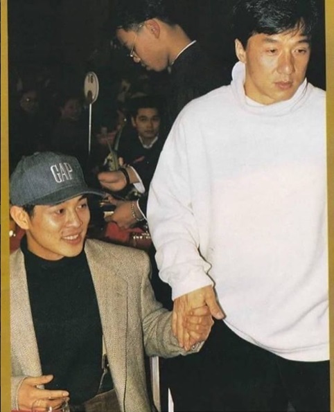 A Chinese man takes his son to school. - Jet Li, Jackie Chan