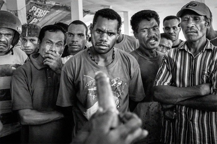 A demonstration of condom use at a public market in Jayapura, the capital of Papua, 2009. - The photo, Education, Papua New Guinea, Condom, Condoms