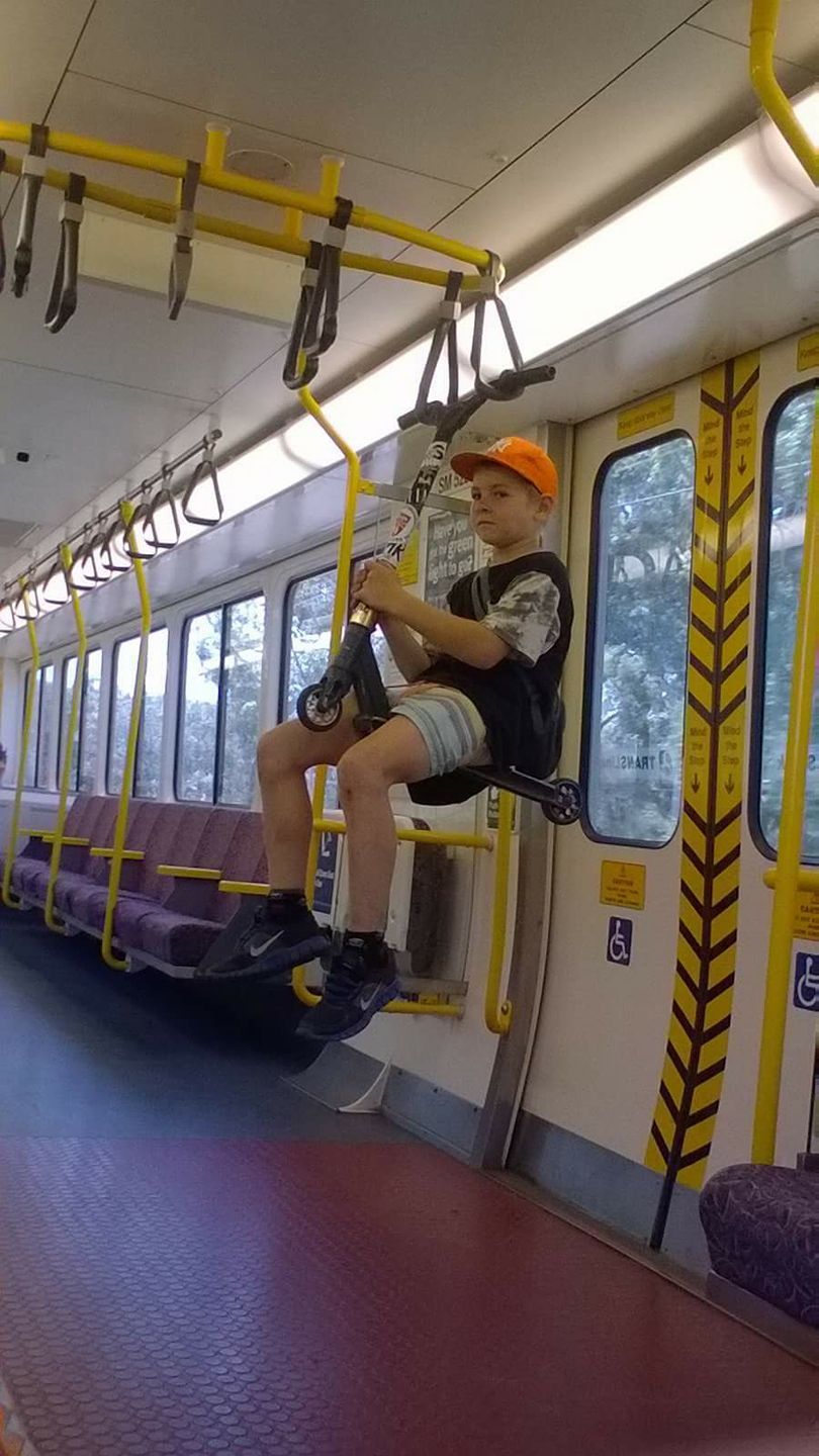 This kid was riding a scooter on a train... - USA, The photo