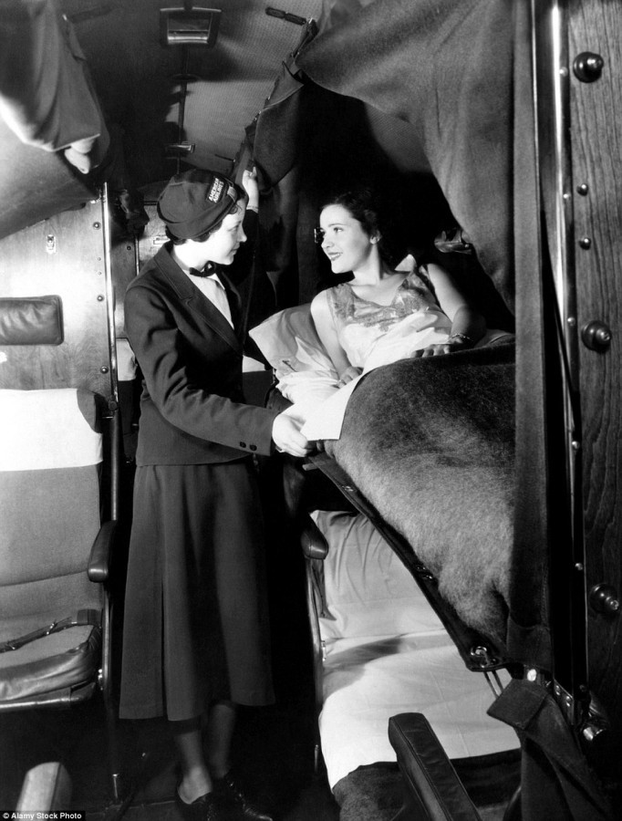 1935: An American Airlines flight attendant wishes a lady passenger a good night's sleep. - Stewardess, Airplane, Retro